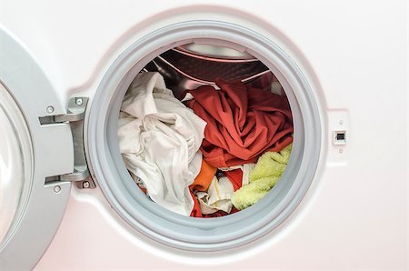 Close up of a washing machine loaded with red and white clothes, colours that shouldn't mix. Stock Photo - Budget Royalty-Free & Subscription, Code: 400-06949864