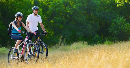 Young Happy Couple Riding Mountain Bikes Outdoor. Healthy Lifestile Concept Photographie de stock - Aubaine LD & Abonnement, Code: 400-06954105