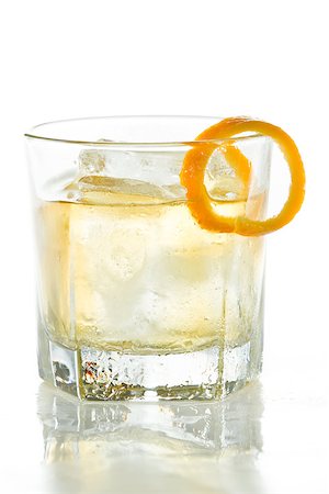 simsearch:400-06797125,k - whiskey served on ice garnished with an orange twist isolated on a white background Stock Photo - Budget Royalty-Free & Subscription, Code: 400-06954147