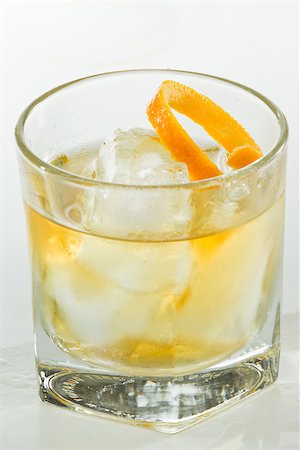 simsearch:400-06797125,k - whiskey served on ice garnished with an orange twist isolated on a white background Stock Photo - Budget Royalty-Free & Subscription, Code: 400-06954148