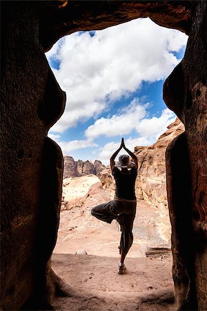simsearch:400-08072896,k - Woman in tree yoga position in the doorway of an ancient tomb in Petra, Jordan Foto de stock - Royalty-Free Super Valor e Assinatura, Número: 400-06954158