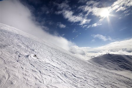 simsearch:400-08780271,k - Off-piste ski slope and blue sky with sun. Georgia, ski resort Gudauri. Caucasus Mountains. Wide-angle view. Photographie de stock - Aubaine LD & Abonnement, Code: 400-06954357