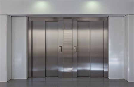 simsearch:400-04225243,k - Two brushed metal elevator doors in a minimalistic style building interior Foto de stock - Super Valor sin royalties y Suscripción, Código: 400-06954724