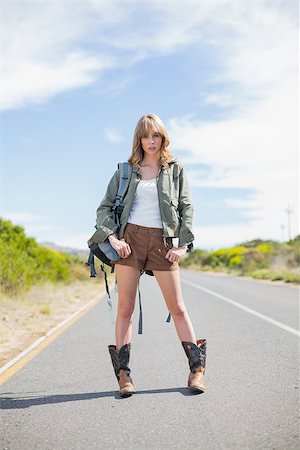 Mysterious sexy blonde posing while hitchhiking on a deserted road in summertime Stockbilder - Microstock & Abonnement, Bildnummer: 400-06955608