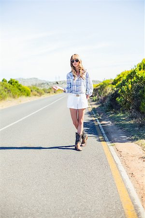 simsearch:400-06956665,k - Trendy blonde with sunglasses hitchhiking on the roadside in the summer Stockbilder - Microstock & Abonnement, Bildnummer: 400-06955682