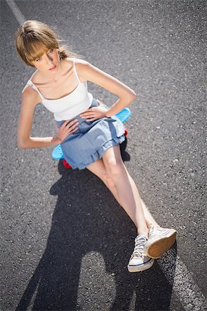 skater (female) - Trendy young woman sitting on her skateboard on a deserted road Stock Photo - Budget Royalty-Free & Subscription, Code: 400-06955881