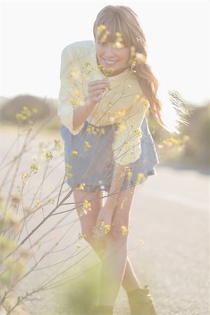 Cheerful hipster girl smelling flowers on a glowing background Stock Photo - Budget Royalty-Free & Subscription, Code: 400-06955921