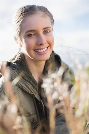 simsearch:400-06956627,k - Beautiful blonde sitting in the countryside smiling at camera Stock Photo - Budget Royalty-Free & Subscription, Code: 400-06956535