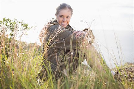 simsearch:400-06956627,k - Woman sitting in grass looking at camera in the countryside Stock Photo - Budget Royalty-Free & Subscription, Code: 400-06956532