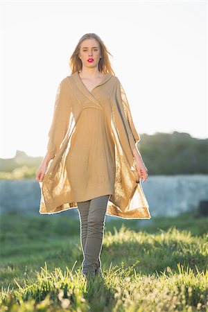 simsearch:400-06956665,k - Attractive blonde woman wearing poncho looking at camera in the countryside Stockbilder - Microstock & Abonnement, Bildnummer: 400-06956660