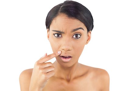 shoulder rides - Gorgeous woman pointing at wrinkle above her lip posing on white background Photographie de stock - Aubaine LD & Abonnement, Code: 400-06956844