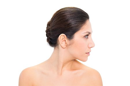 Brunette turning her head to the right and looking on white background Photographie de stock - Aubaine LD & Abonnement, Code: 400-06957921