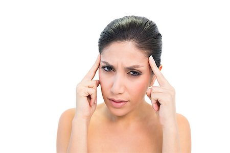 Brunette with a headache touching her temples on white background Stock Photo - Budget Royalty-Free & Subscription, Code: 400-06957947