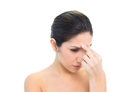 simsearch:400-06960125,k - Frowning brunette with a headache pinching her nose on white background Photographie de stock - Aubaine LD & Abonnement, Code: 400-06957949