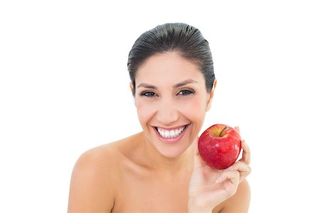 Happy brunette holding a red apple and looking at camera on white background Stock Photo - Budget Royalty-Free & Subscription, Code: 400-06958145