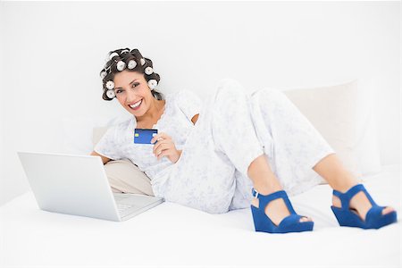 simsearch:693-06323945,k - Brunette in hair rollers and wedge shoes using her laptop to shop online on bed xin bedroom at home Stock Photo - Budget Royalty-Free & Subscription, Code: 400-06958260