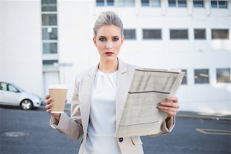 street coffee - Serious stylish businesswoman holding newspaper and coffee outdoors on urban background Stock Photo - Budget Royalty-Free & Subscription, Code: 400-06958625