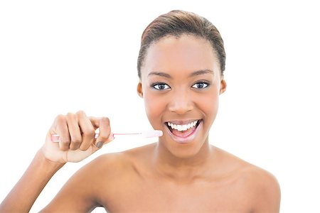 simsearch:400-06960125,k - Smiling beautiful model holding toothbrush on white background Photographie de stock - Aubaine LD & Abonnement, Code: 400-06958906