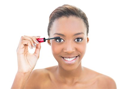 simsearch:400-06960125,k - Smiling beautiful model applying mascara on white background Photographie de stock - Aubaine LD & Abonnement, Code: 400-06958902