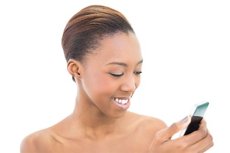 simsearch:400-06960125,k - Natural beauty looking at her smartphone on white background Photographie de stock - Aubaine LD & Abonnement, Code: 400-06958917
