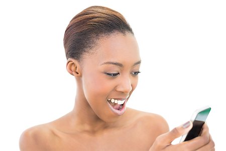 simsearch:400-06960125,k - Happy natural beauty looking at her smartphone on white background Photographie de stock - Aubaine LD & Abonnement, Code: 400-06958919