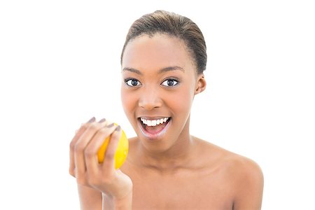 simsearch:400-06960125,k - Surprised natural beauty holding orange on white background Photographie de stock - Aubaine LD & Abonnement, Code: 400-06958929