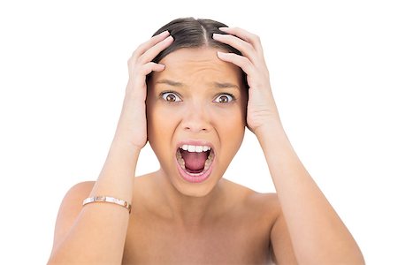 Screaming woman holding hands on head against white background Photographie de stock - Aubaine LD & Abonnement, Code: 400-06959014