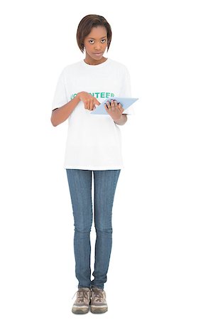 Serious volunteer woman using tablet pc on white background Stockbilder - Microstock & Abonnement, Bildnummer: 400-06959152