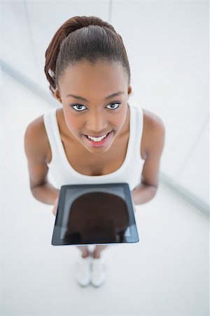 High angle view of smiling sporty woman holding tablet in bright fitness studio Stock Photo - Budget Royalty-Free & Subscription, Code: 400-06959342