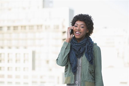 simsearch:400-08430017,k - Smiling casual model on the phone outdoors on a sunny day Stock Photo - Budget Royalty-Free & Subscription, Code: 400-06959434