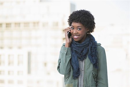 simsearch:400-08430017,k - Cheerful afro model on the phone outdoors on a sunny day Stock Photo - Budget Royalty-Free & Subscription, Code: 400-06959438