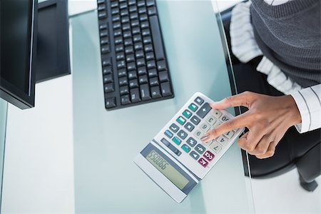 Close up on businesswoman using calculator in bright office Photographie de stock - Aubaine LD & Abonnement, Code: 400-06959462