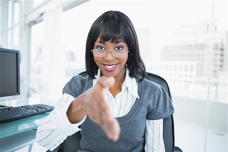 Smiling gorgeous businesswoman offering hand in bright office Stock Photo - Budget Royalty-Free & Subscription, Code: 400-06959478
