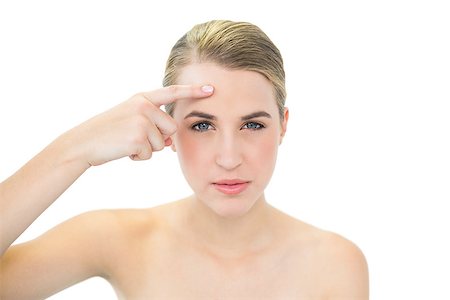 shoulder rides - Pretty blonde pointing at wrinkle on her forehead while posing on white background Photographie de stock - Aubaine LD & Abonnement, Code: 400-06959503