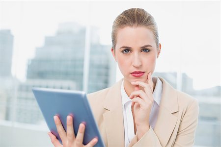 simsearch:400-06802290,k - Serious attractive businesswoman in bright office using her tablet Stock Photo - Budget Royalty-Free & Subscription, Code: 400-06959975