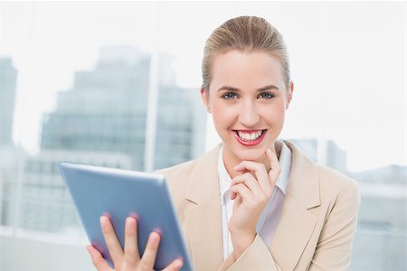 simsearch:400-06802290,k - Happy attractive businesswoman in bright office using her tablet Stock Photo - Budget Royalty-Free & Subscription, Code: 400-06959976