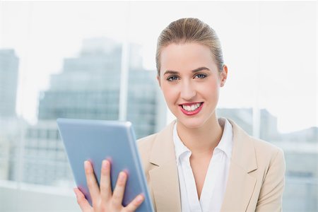 simsearch:400-06802290,k - Cheerful attractive businesswoman in bright office using her tablet Stock Photo - Budget Royalty-Free & Subscription, Code: 400-06959973