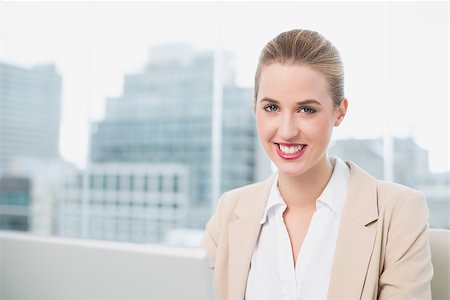 simsearch:400-05663929,k - Smiling gorgeous businesswoman working on her laptop in bright office Stock Photo - Budget Royalty-Free & Subscription, Code: 400-06959998