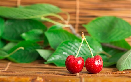 simsearch:400-08110532,k - Two Cherries close up. Branch with leaves. Studio shot Stock Photo - Budget Royalty-Free & Subscription, Code: 400-06950367