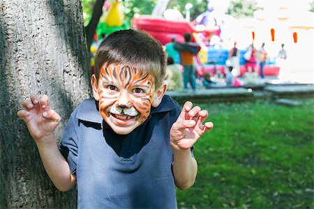 Child with painted face. Tiger paint. Boy on children's holiday Stock Photo - Budget Royalty-Free & Subscription, Code: 400-06950379