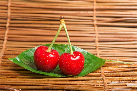simsearch:400-08110532,k - Two Cherries close up. Branch with leaves. Studio shot Stock Photo - Budget Royalty-Free & Subscription, Code: 400-06950370