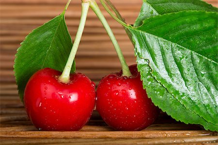 simsearch:400-08110532,k - Two Cherries close up. Branch with leaves. Studio shot Stock Photo - Budget Royalty-Free & Subscription, Code: 400-06950372