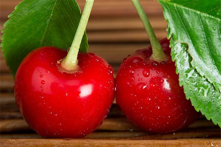 simsearch:400-08110532,k - Two Cherries close up. Branch with leaves. Studio shot Stock Photo - Budget Royalty-Free & Subscription, Code: 400-06950373
