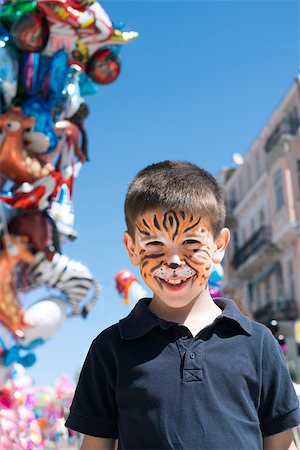 Child with painted face. Tiger paint. Boy on children's holiday Stock Photo - Budget Royalty-Free & Subscription, Code: 400-06950380