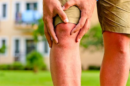 man holding hands sore knee Fotografie stock - Microstock e Abbonamento, Codice: 400-06950899