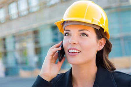 Young Professional Female Contractor Wearing Hard Hat at Contruction Site Using Cell Phone. Stock Photo - Budget Royalty-Free & Subscription, Code: 400-06951135