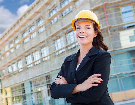 Portrait of Young Attractive Professional Female Contractor Wearing Hard Hat at Construction Site. Stock Photo - Budget Royalty-Free & Subscription, Code: 400-06951136