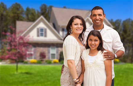 Happy Hispanic Mother, Father and Daughter in Front of Their Home. Stock Photo - Budget Royalty-Free & Subscription, Code: 400-06951155
