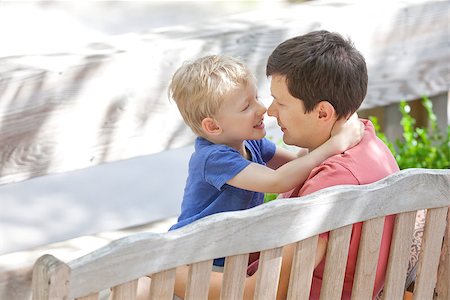 adorable son and his handsome father sitting and touching each other with noses Stock Photo - Budget Royalty-Free & Subscription, Code: 400-06951173