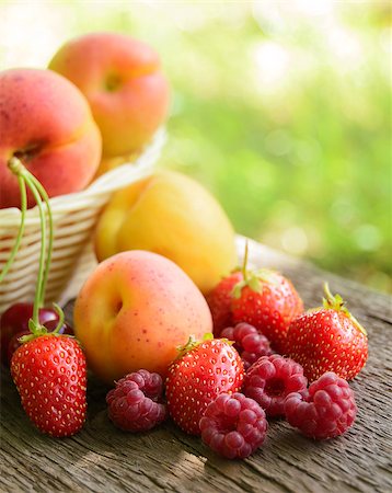 simsearch:400-07667203,k - Fresh Ripe Sweet Fruits on the Wooden Table in the Garden. Fresh Organic Food Stock Photo - Budget Royalty-Free & Subscription, Code: 400-06951431